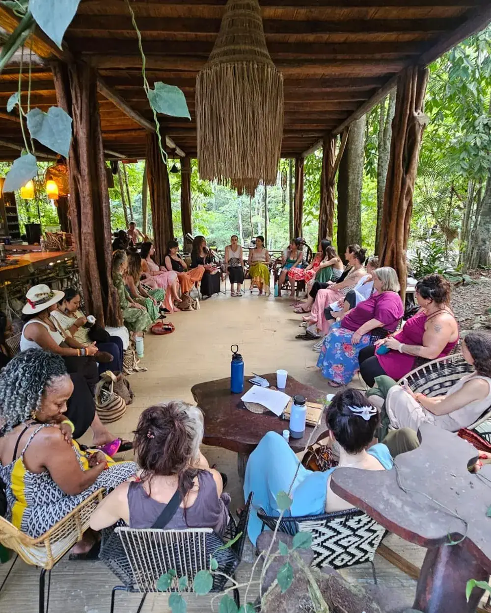 Group gathered at a long table under a roof